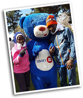 Jane Murage and Paul Kimugul, 2017 winners, with Beemo the Bear